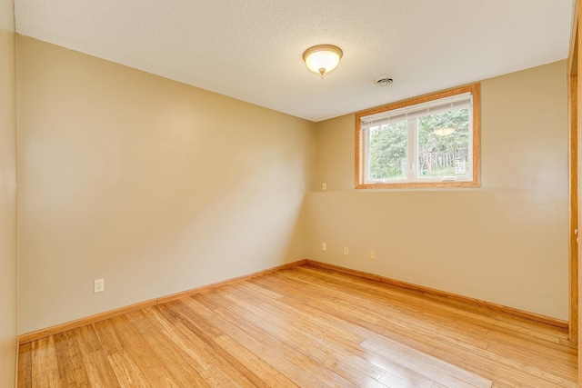 121 Yorkton Rdg, Little Canada, MN 55117 - unfurnished room with light wood-style flooring, baseboards, and a textured ceiling