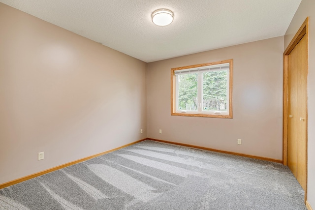121 Yorkton Rdg, Little Canada, MN 55117 - unfurnished bedroom with carpet flooring, baseboards, and a textured ceiling