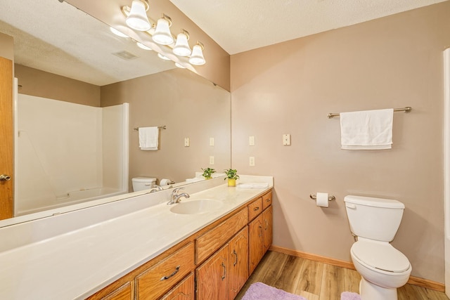 121 Yorkton Rdg, Little Canada, MN 55117 - full bathroom with toilet, wood finished floors, vanity, baseboards, and  shower combination
