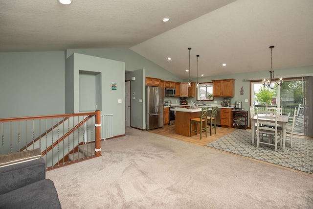 802 10th St NE, Kasson, MN 55944 - living area featuring lofted ceiling, light colored carpet, a chandelier, recessed lighting, and baseboards