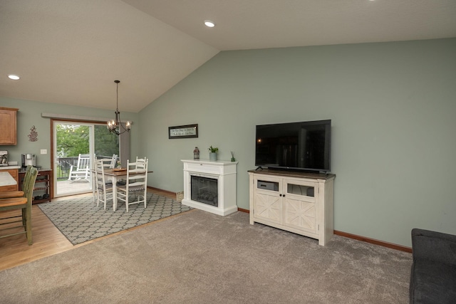 802 10th St NE, Kasson, MN 55944 - carpeted living area featuring vaulted ceiling, a chandelier, recessed lighting, baseboards, and a glass covered fireplace