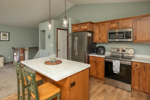 802 10th St NE, Kasson, MN 55944 - kitchen featuring stainless steel appliances, lofted ceiling, brown cabinetry, light countertops, and a kitchen island