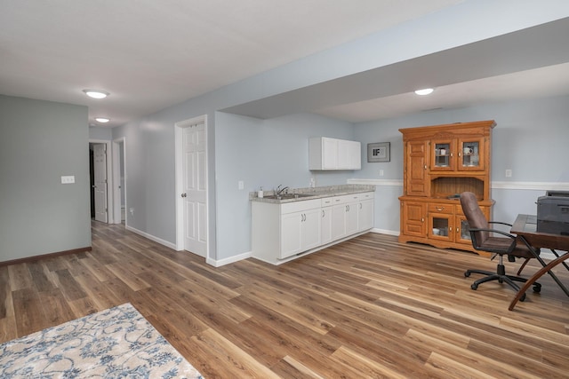 802 10th St NE, Kasson, MN 55944 - office space featuring a sink, light wood finished floors, and baseboards