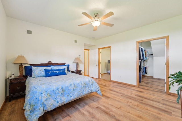 6509 154th St W, Apple Valley, MN 55124 - bedroom with wood finished floors, baseboards, a spacious closet, ceiling fan, and ensuite bath