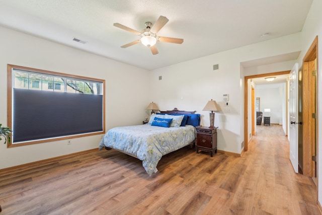 6509 154th St W, Apple Valley, MN 55124 - bedroom with light wood finished floors, a ceiling fan, and baseboards