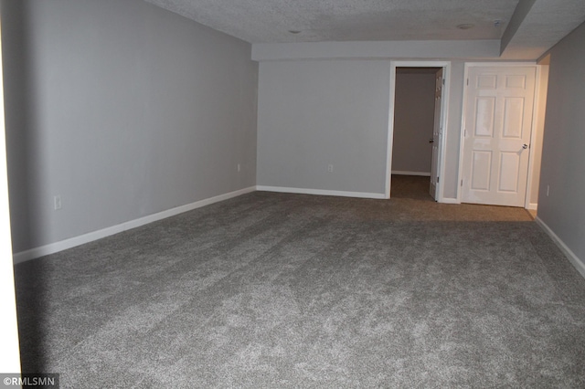 1310 Pacific St, Saint Paul, MN 55106 - empty room with dark colored carpet, baseboards, and a textured ceiling