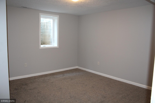 1310 Pacific St, Saint Paul, MN 55106 - empty room with a textured ceiling, carpet, and baseboards