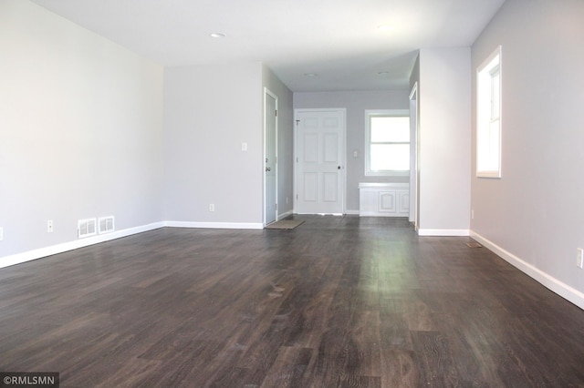 1310 Pacific St, Saint Paul, MN 55106 - spare room featuring dark wood-type flooring and baseboards