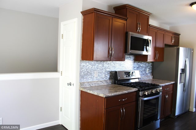 1310 Pacific St, Saint Paul, MN 55106 - kitchen with appliances with stainless steel finishes, tasteful backsplash, and dark wood finished floors