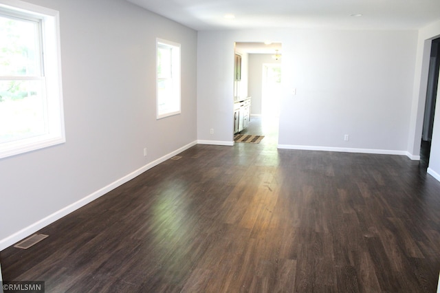 1310 Pacific St, Saint Paul, MN 55106 - spare room featuring dark wood-style floors and baseboards