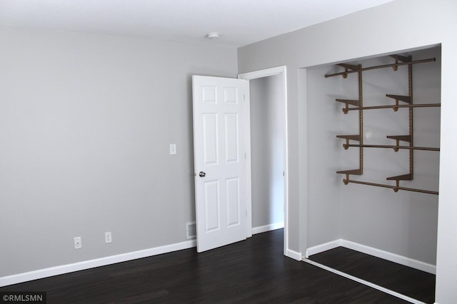 1310 Pacific St, Saint Paul, MN 55106 - empty room with dark wood-style floors, baseboards, and a smoke detector
