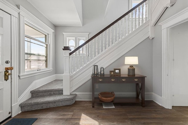 stairway featuring wood finished floors and baseboards