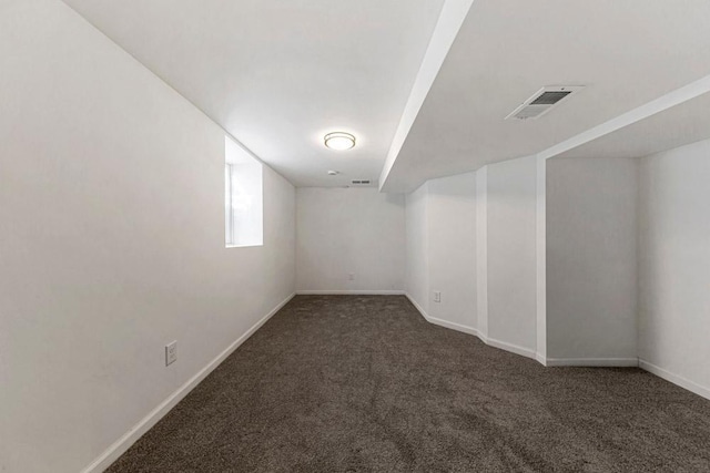 basement featuring carpet floors and baseboards