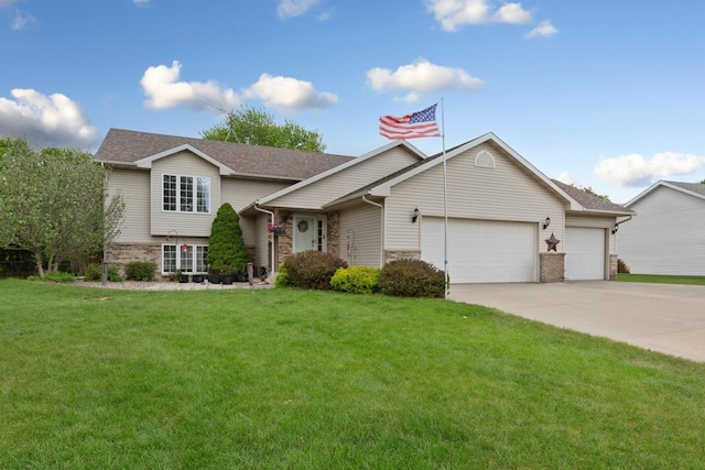 split level home featuring a garage, a front yard, and concrete driveway