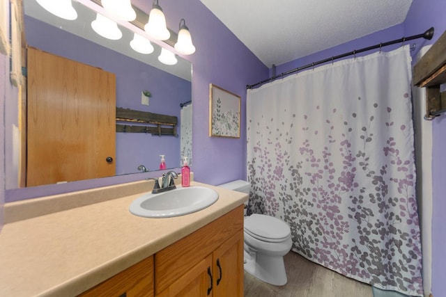 full bathroom featuring toilet, wood finished floors, vanity, and a shower with curtain