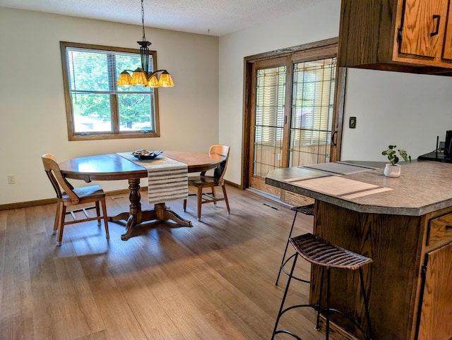 1401 5th St, Montevideo, MN 56265 - dining area with light wood finished floors, baseboards, and a textured ceiling