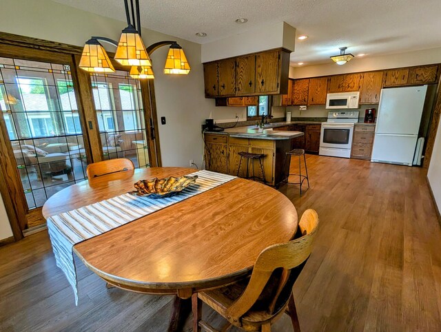 1401 5th St, Montevideo, MN 56265 - dining area featuring wood finished floors, a textured ceiling, and recessed lighting