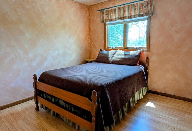 1401 5th St, Montevideo, MN 56265 - bedroom with baseboards, wood finished floors, and a textured wall