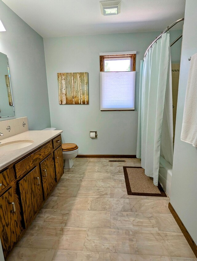1401 5th St, Montevideo, MN 56265 - bathroom featuring toilet, vanity, baseboards, and marble finish flooring