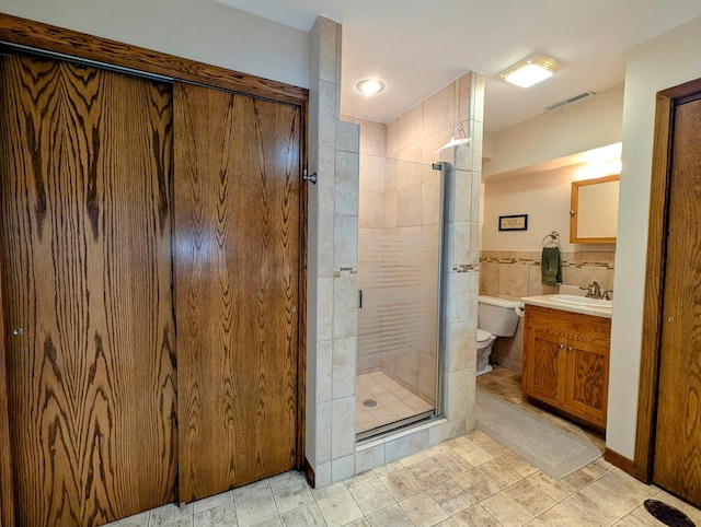 1401 5th St, Montevideo, MN 56265 - bathroom with a stall shower, toilet, vanity, and tile walls