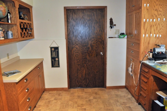 1401 5th St, Montevideo, MN 56265 - kitchen featuring baseboards, light countertops, brown cabinets, and open shelves