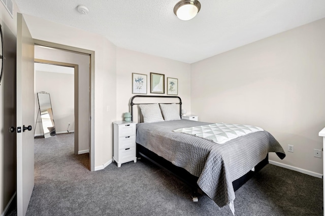 bedroom featuring dark carpet and baseboards