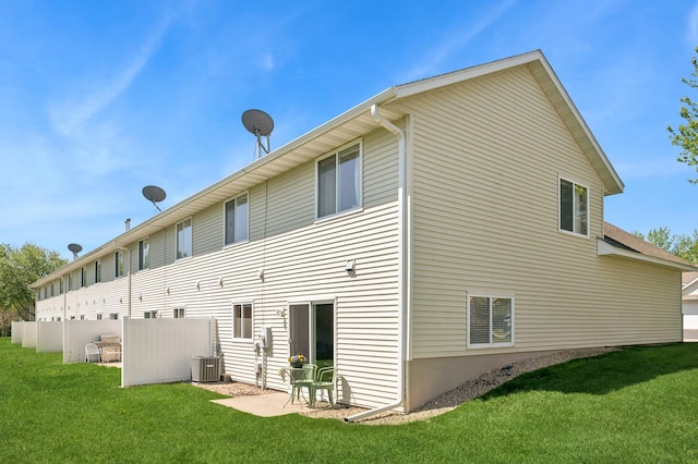 rear view of property featuring central AC
