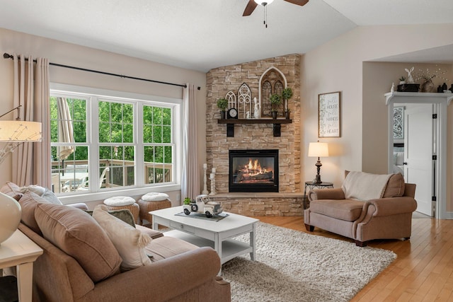 855 Elins Lake Rd SE, Cambridge, MN 55008 - living area with a fireplace, ceiling fan, lofted ceiling, and light wood-style floors