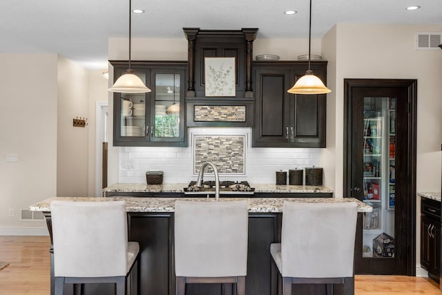 855 Elins Lake Rd SE, Cambridge, MN 55008 - kitchen featuring tasteful backsplash, light wood-style flooring, light stone counters, and recessed lighting