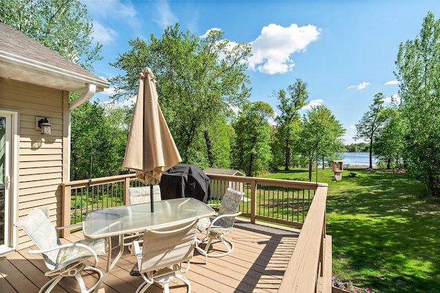 855 Elins Lake Rd SE, Cambridge, MN 55008 - wooden terrace featuring outdoor dining area, a water view, and a lawn