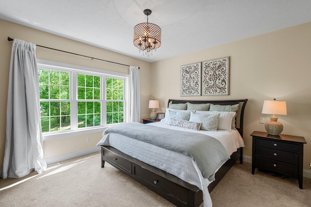 855 Elins Lake Rd SE, Cambridge, MN 55008 - carpeted bedroom featuring a chandelier and baseboards