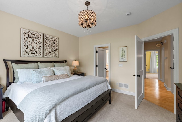 855 Elins Lake Rd SE, Cambridge, MN 55008 - bedroom featuring a chandelier, baseboards, and light colored carpet