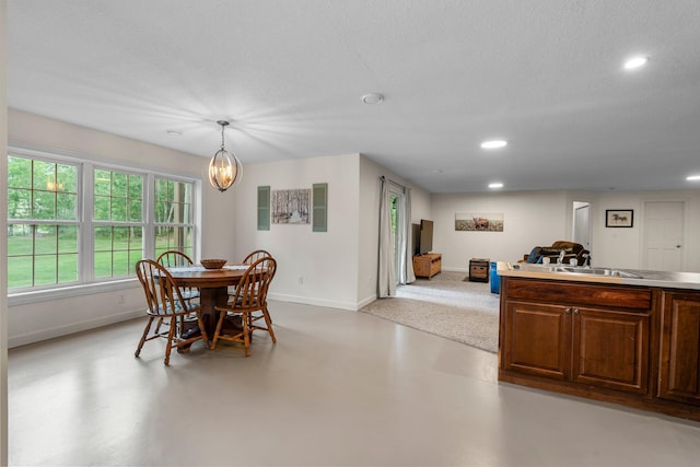 855 Elins Lake Rd SE, Cambridge, MN 55008 - dining space featuring baseboards, recessed lighting, finished concrete flooring, a chandelier, and a textured ceiling
