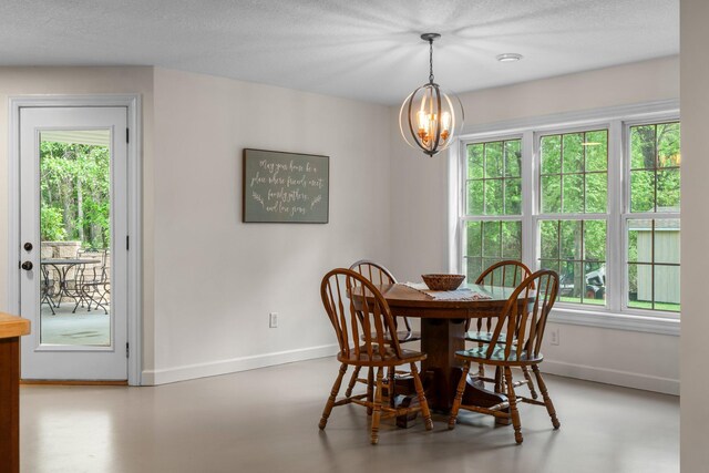 855 Elins Lake Rd SE, Cambridge, MN 55008 - dining area featuring baseboards, healthy amount of natural light, a chandelier, and a textured ceiling