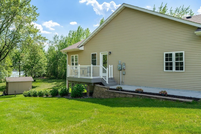 855 Elins Lake Rd SE, Cambridge, MN 55008 - view of side of home featuring a yard, a wooden deck, an outbuilding, and a storage shed