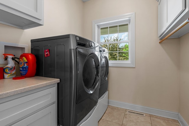855 Elins Lake Rd SE, Cambridge, MN 55008 - laundry area with cabinet space, washing machine and clothes dryer, baseboards, and light tile patterned floors