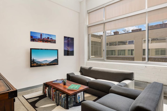 living area featuring baseboards and concrete flooring
