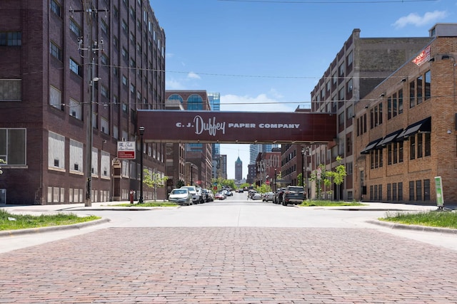 view of street with curbs, street lights, and sidewalks