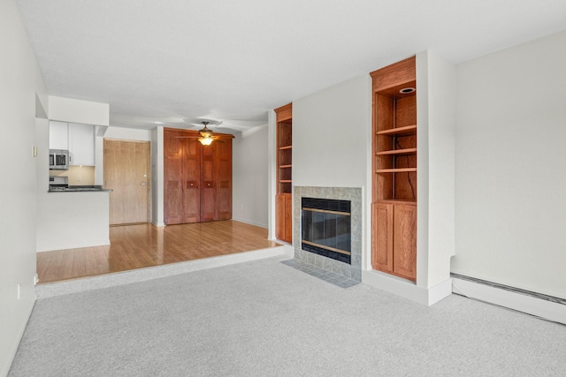 4820 Park Commons Dr Unit 329, Saint Louis Park, MN 55416 - unfurnished living room with carpet floors, a fireplace, a ceiling fan, baseboard heating, and heating unit
