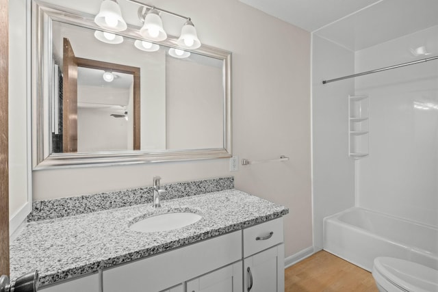 4820 Park Commons Dr Unit 329, Saint Louis Park, MN 55416 - bathroom featuring vanity, toilet, wood finished floors, and  shower combination