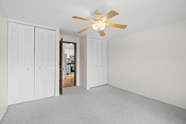 4820 Park Commons Dr Unit 329, Saint Louis Park, MN 55416 - unfurnished bedroom featuring multiple closets, carpet flooring, baseboards, and a ceiling fan