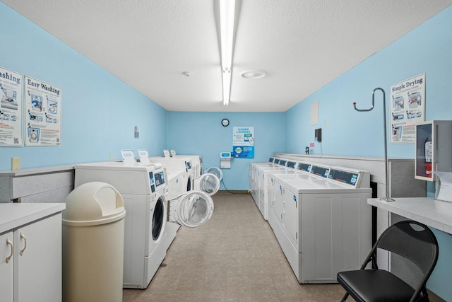 4820 Park Commons Dr Unit 329, Saint Louis Park, MN 55416 - laundry room featuring cabinet space, washing machine and dryer, a textured ceiling, and light flooring
