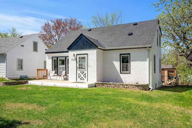 4528 6th St NE, Columbia Heights, MN 55421 - back of house with a shingled roof, a lawn, and stucco siding