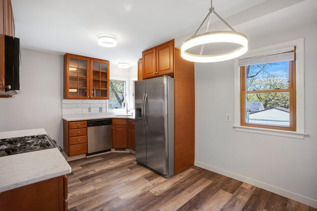 4528 6th St NE, Columbia Heights, MN 55421 - kitchen featuring appliances with stainless steel finishes, brown cabinetry, a sink, and healthy amount of natural light