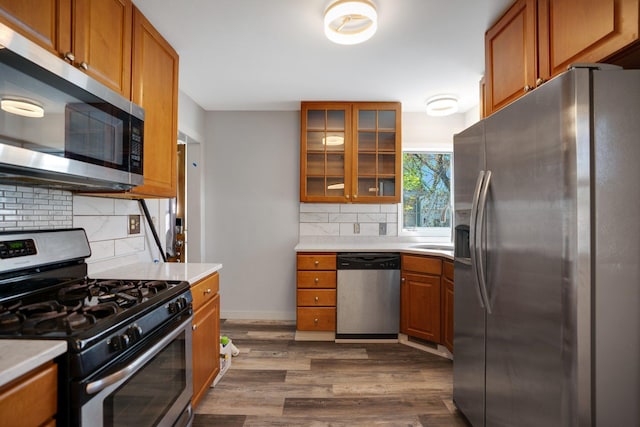 4528 6th St NE, Columbia Heights, MN 55421 - kitchen featuring appliances with stainless steel finishes, brown cabinets, and backsplash