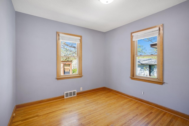 4528 6th St NE, Columbia Heights, MN 55421 - spare room featuring healthy amount of natural light, light wood-style floors, and baseboards