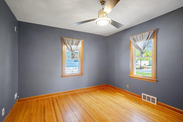 4528 6th St NE, Columbia Heights, MN 55421 - unfurnished room with wood finished floors, ceiling fan, and baseboards