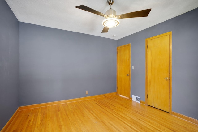 4528 6th St NE, Columbia Heights, MN 55421 - unfurnished room with wood finished floors, baseboards, and a ceiling fan