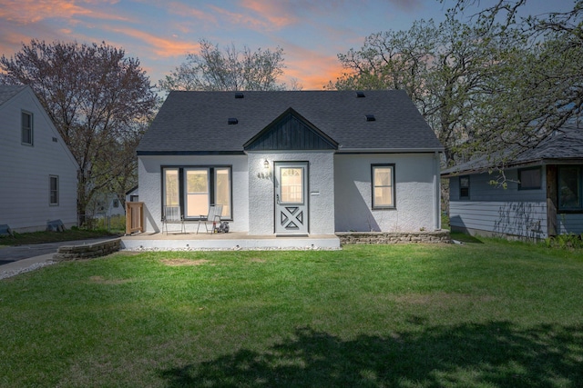4528 6th St NE, Columbia Heights, MN 55421 - rear view of house featuring a lawn, a shingled roof, and a porch