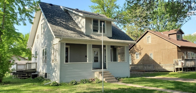217 Flynn St, Redwood Falls, MN 56283 - bungalow featuring a front yard, a deck, and roof with shingles